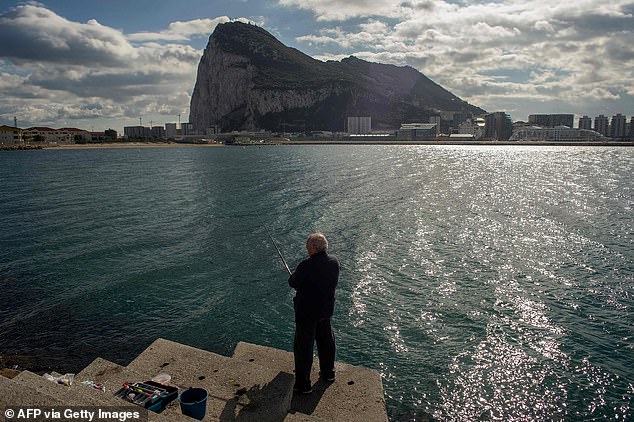 Since December 2020, a post-Brexit deal between the UK, Spain and the EU has allowed citizens of Gibraltar to remain part of the border-free Schengen area among other EU agreements. Pictured: A man looks out to the Rock of Gibraltar from La Linea (file pic)