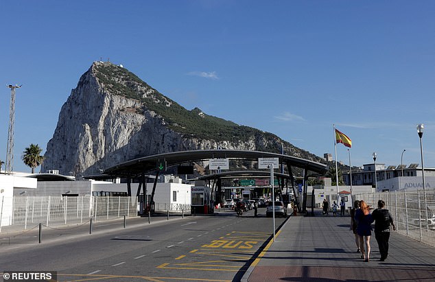 The situation has become all the more urgent as the European Union 's new digital border system creeps closer to being implemented. Pictured: Pedestrians and drivers cross the border from Spain to Gibraltar, in front of the Rock of Gibraltar, in La Linea (file pic)