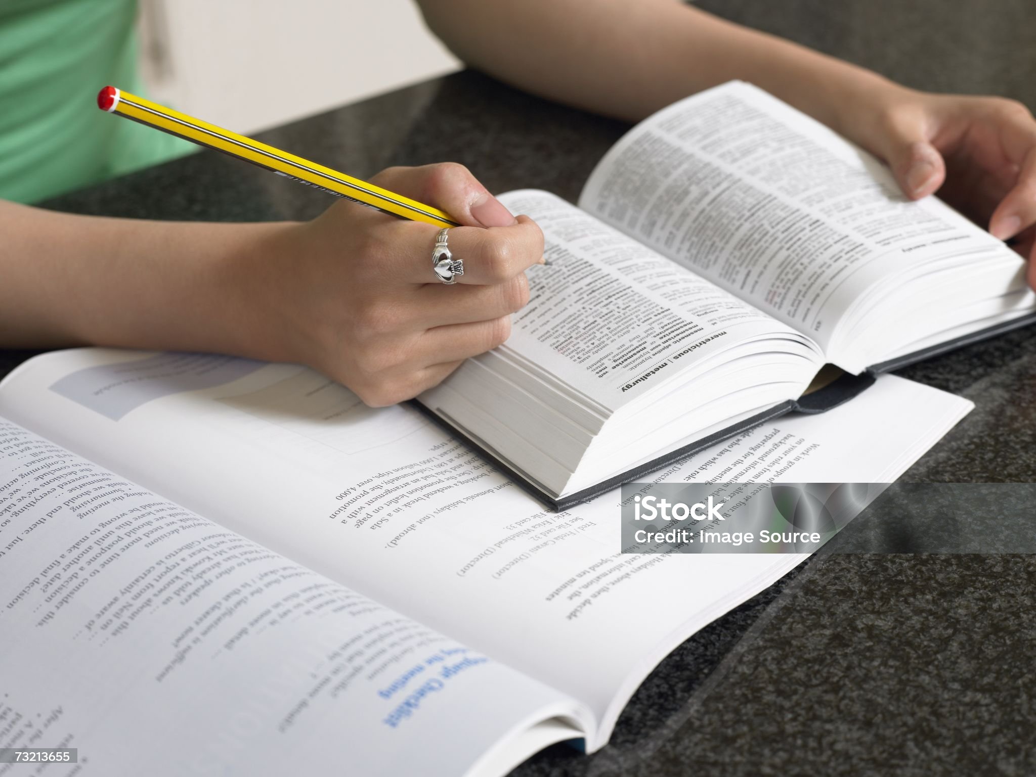 Student with dictionary and textbook