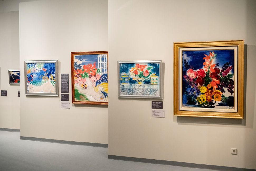 Paintings in gilt frames hanging on a museum wall