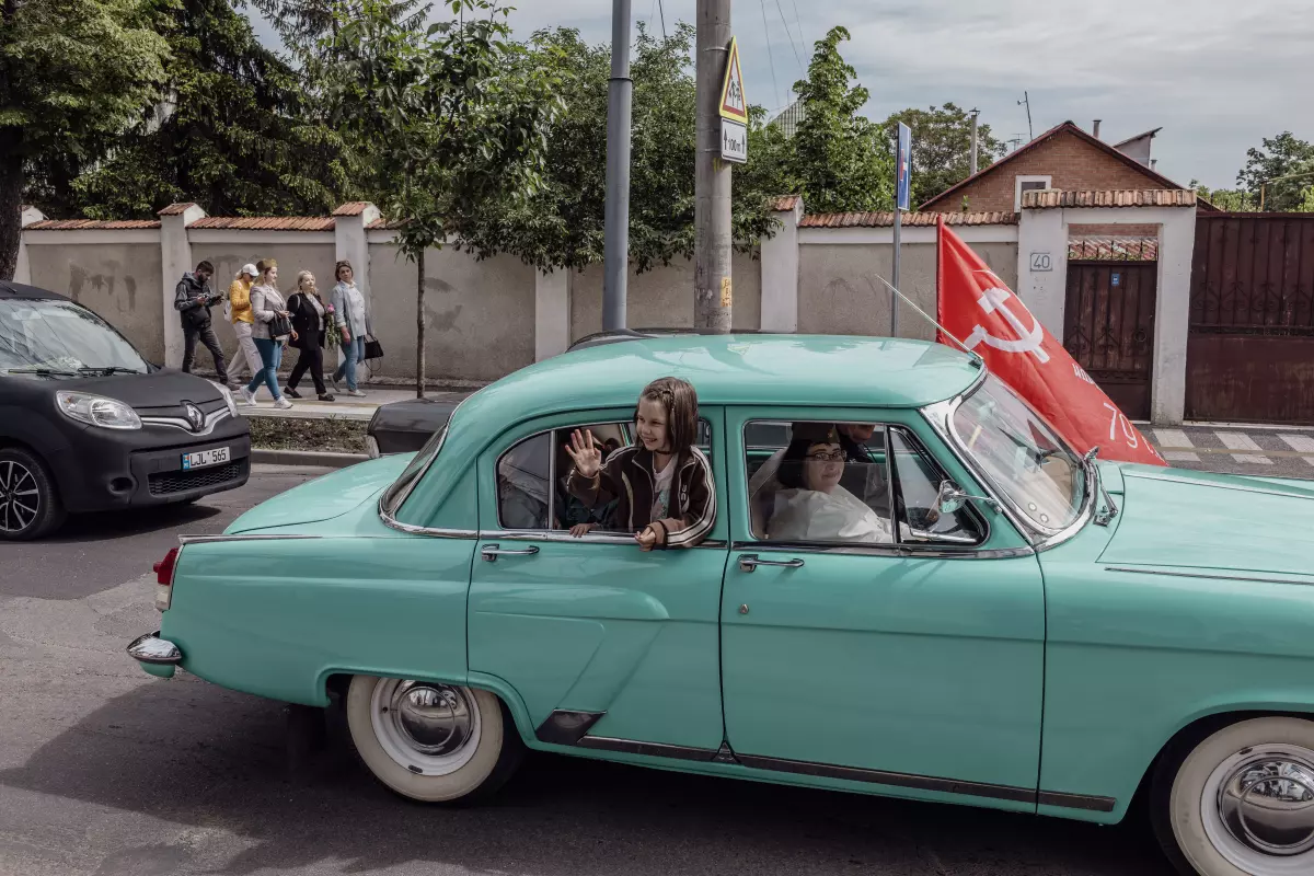 A girl waved out the window of a car during a Victory Day parade in Chișinău, Moldova, May 9. Many from Moldova’s Russian-speaking population remain nostalgic for the days of the former Soviet Union.
