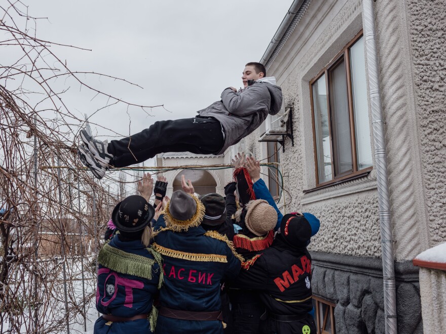 A boy is tossed into the air during the celebration of Malanka, a Ukrainian folk holiday with Christian-pagan roots, in Vălcineț, Ocnița district, Moldova, Jan. 13. Ukrainian is still widely spoken in Vălcineț.