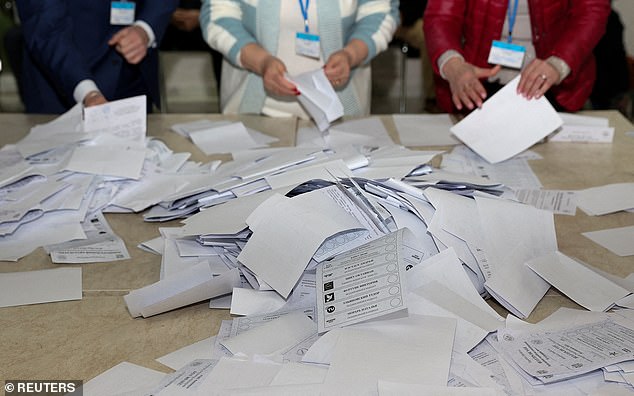 Members of an electoral commission count votes after polling stations closed in the course of Moldova's presidential election and a referendum on joining the European Union, in Chisinau, Moldova October 20, 2024