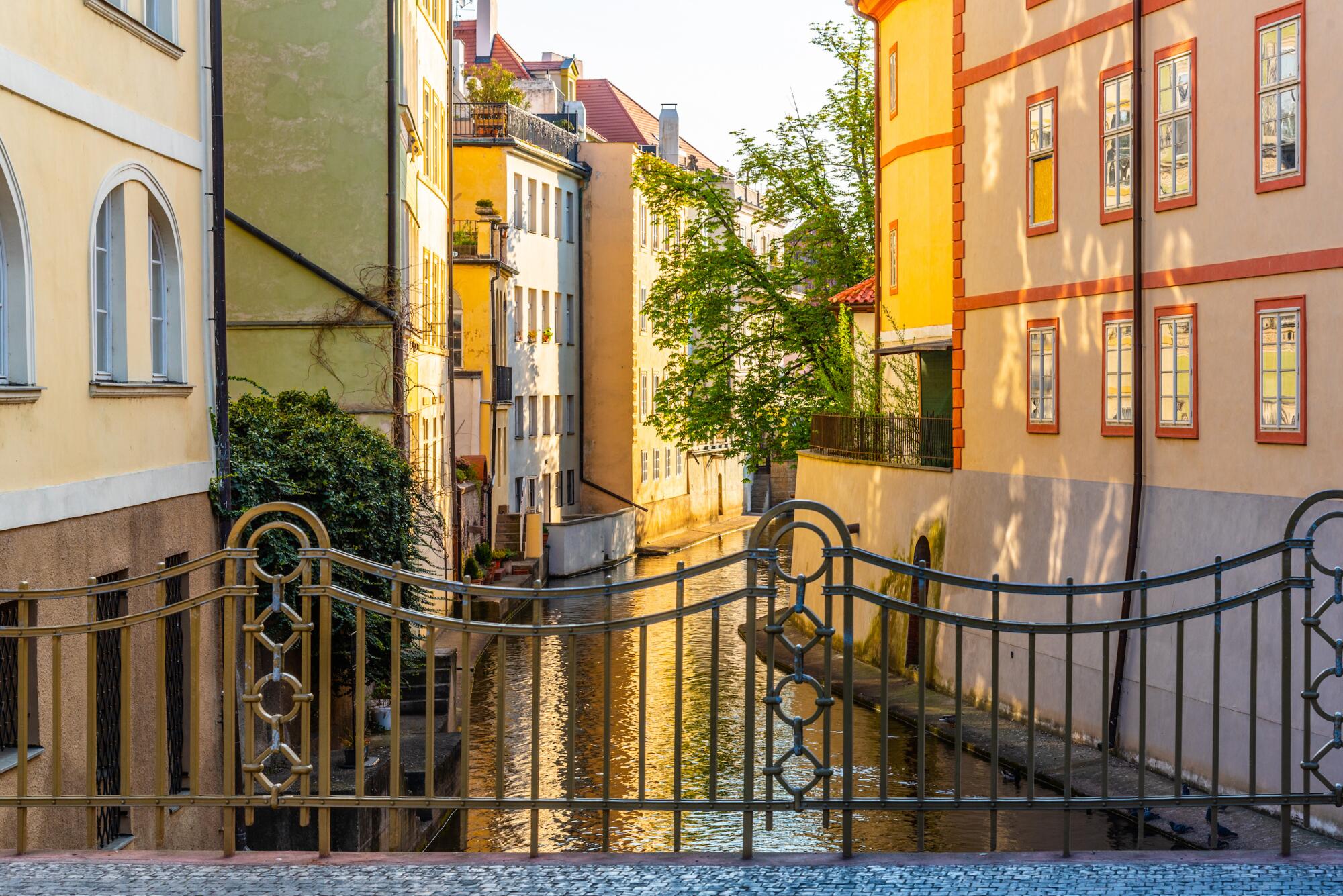 Narrow canal under Charlse Bridge in Lesser Town, Prague, Czech Republic.