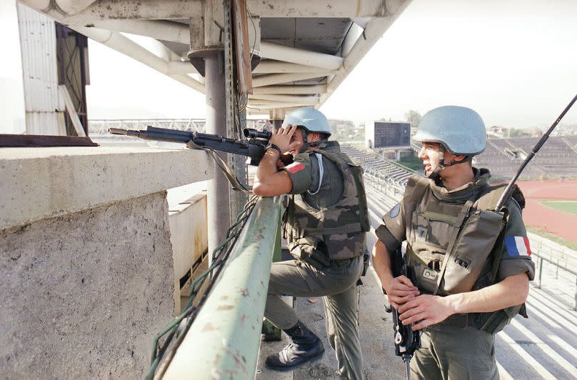 Two French UN Peacekeepers from the anti-sniper unit observe confrontation lines from their positions in the Olympic stadium in Sarajevo, Sept. 27, 1994.