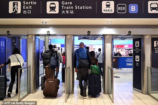 Passenger exit a terminal on the sidelines of a visit by the French minister for Budget and Public Accounts at the Roissy-Charles de Gaulle airport, in the northern outskirts of Paris, on October 18