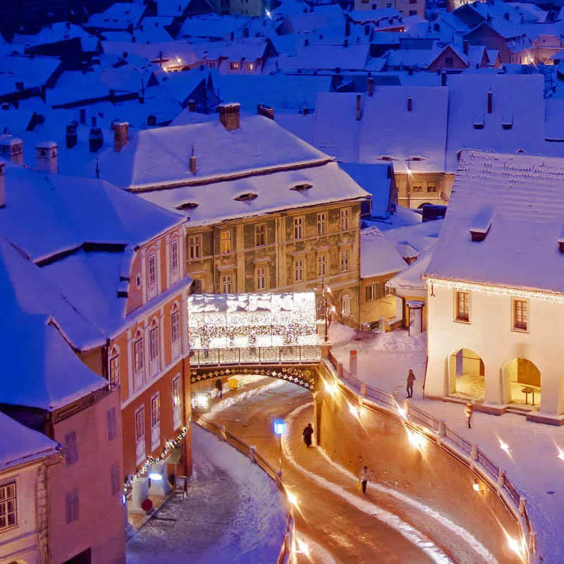 Aerial View Of Old Town Sibiu And The Bridge Of Lies Blanketed By Snow, Transylvania, Romania