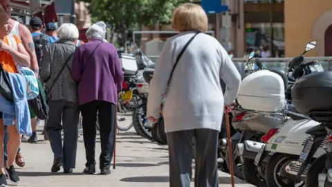 Getty Images Elderly women in Mallorca walking with sticks