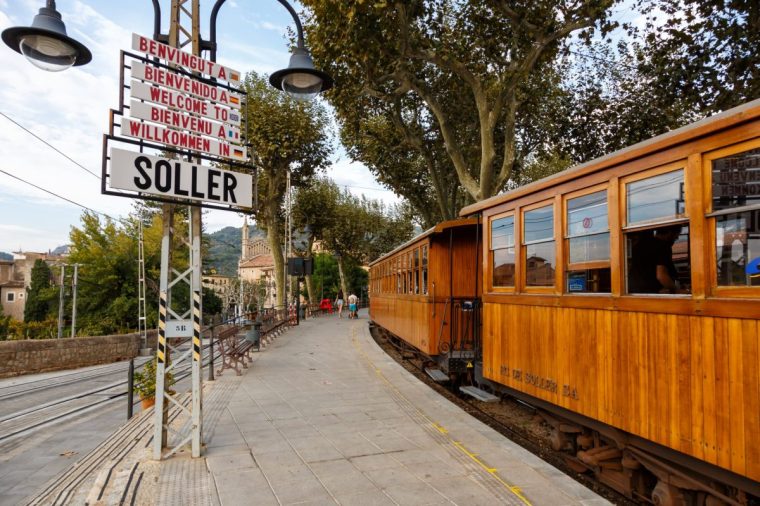 Soller, Spain - October 21, 2021: Ancient train Tren de Soller public transport transit transportation at Soller railway station on Mallorca in Spain.