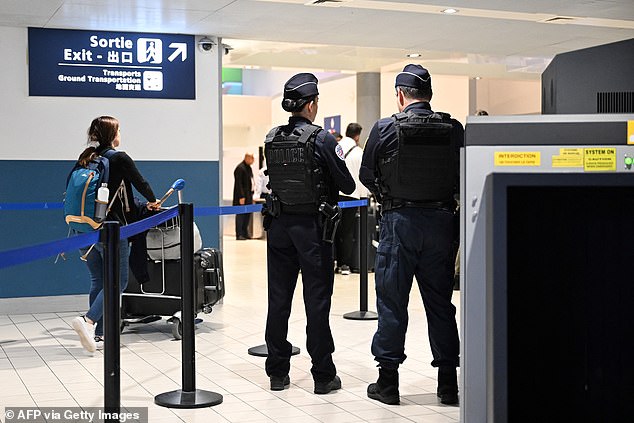 Police stand at a customs checkpoint at the Roissy-Charles de Gaulle airport, in the northern outskirts of Paris, on October 18, 2024