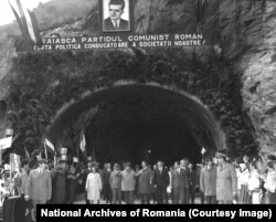 Nicolae and Elena Ceausescu attend the official opening of the Transfagarasan on September 20, 1974. The propaganda banner declares: 