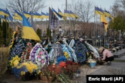 Ukrainian military graves at a cemetery outside of Kyiv in March