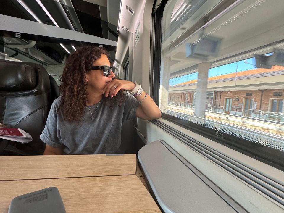 jamie looking out the window on a train in europe