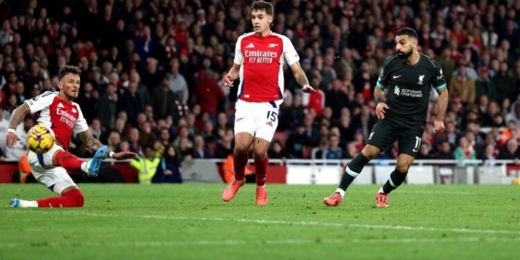 Mohamed Salah (R) scores to earn Liverpool a 2-2 Premier League draw at Arsenal. (Adrian Dennis)