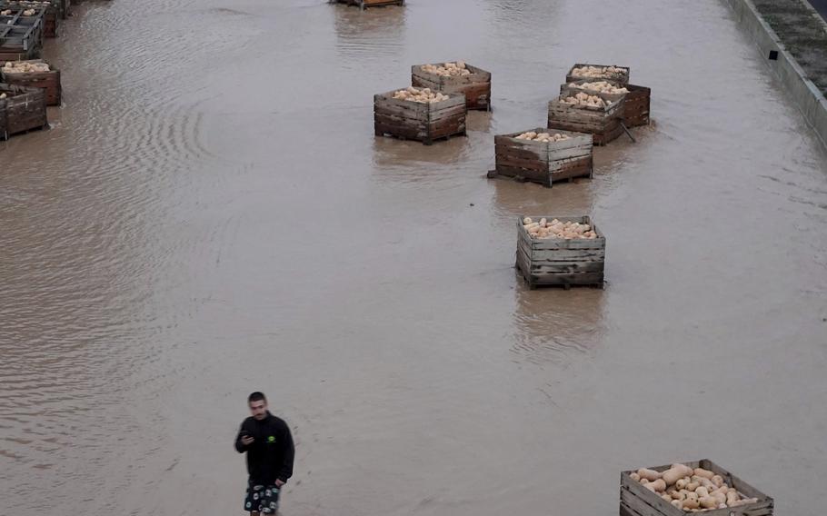 A man walks on a flooded motorway in Valencia.