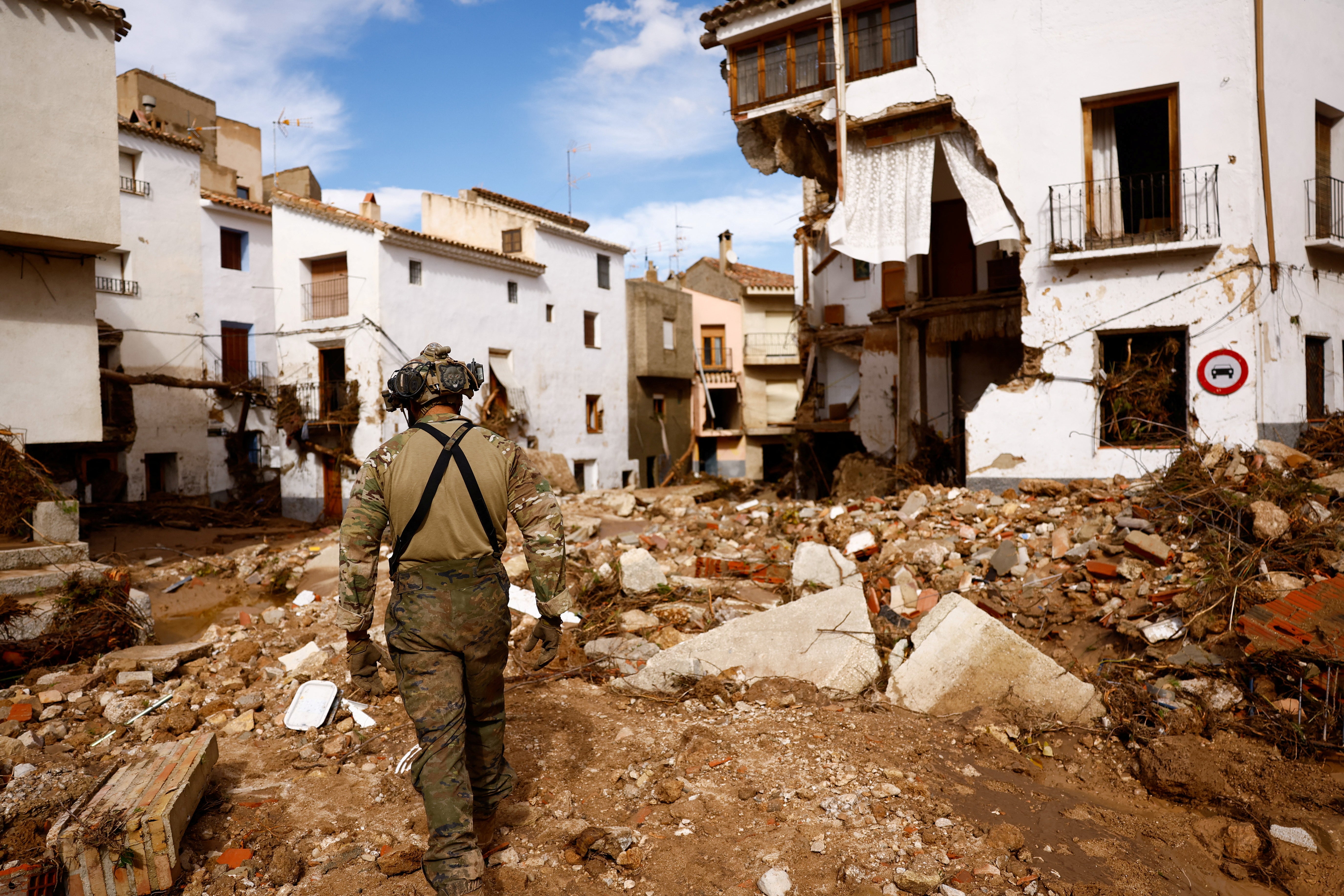 A member of Spanish UME military unit walks on the debris after heavy rains caused flooding, in Letur