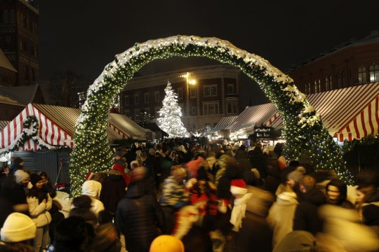 People attend a traditional Christmas market in Riga, Latvia