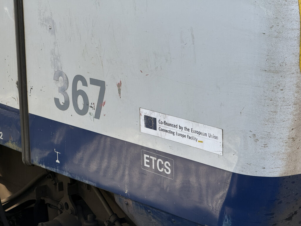 A close up of the train shows a notice that it was financed by the EU