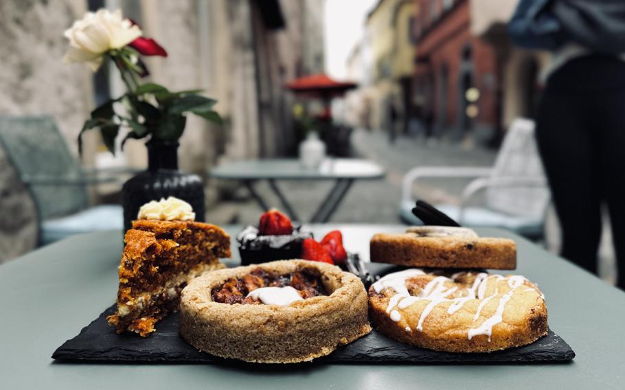 Large cookies are shown on a table with the town in the background.