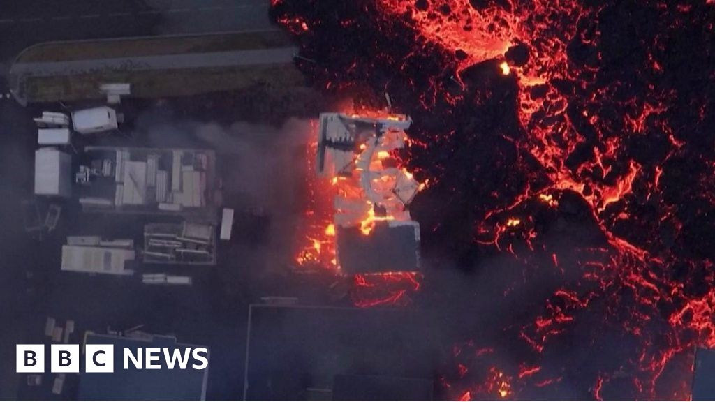 Aerial footage shows lava burning houses