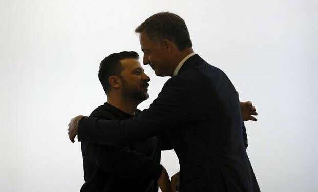 Ukraine's President Volodymyr Zelenskyy, left, is welcomed by Belgium's Prime Minister Alexander De Croo