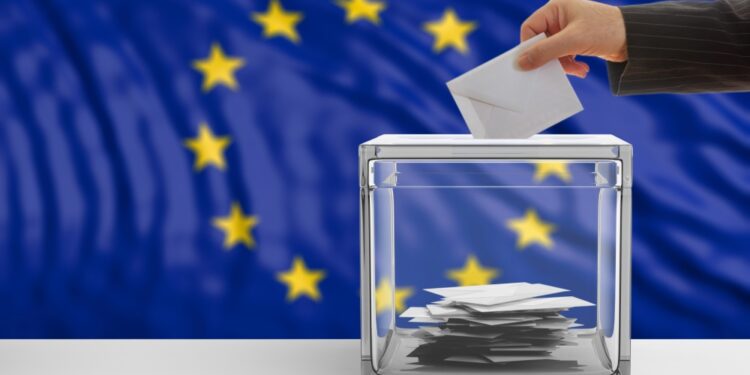 someone places its vote inside a transparent box with the EU flag on the background