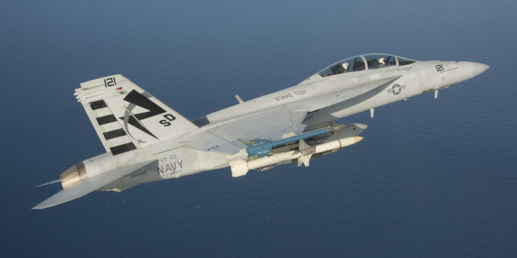 An F/A-18F Super Hornet assigned to the Salty Dogs of Air Test and Evaluation Squadron (VX) 23 conducts a captive carry flight test of an AGM-88E Advanced Anti-Radiation Guided Missile at Naval Air Station Patuxent River, Md. (U.S. Navy photo by: Greg L. Davis)