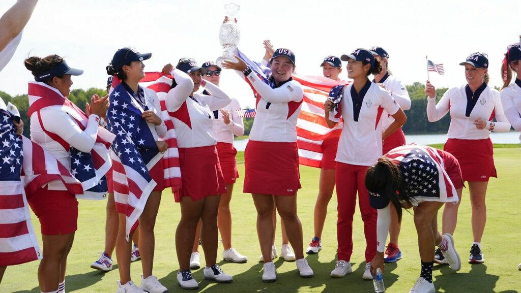 Punahou School graduate Allisen Corpuz, center, held the winner's trophy after the U.S. won the Solheim Cup over Europe at Robert Trent Jones Golf Club in Gainesville, Va., on Sunday.