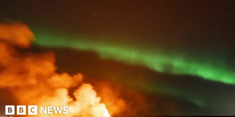 Iceland: Northern Lights captured glowing over erupting volcano – BBC.com