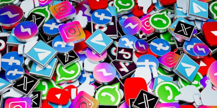 A large collection of metal badges in the shape of social media platform logos such as Instagram, Facebook, X, WhatsApp and YouTube.