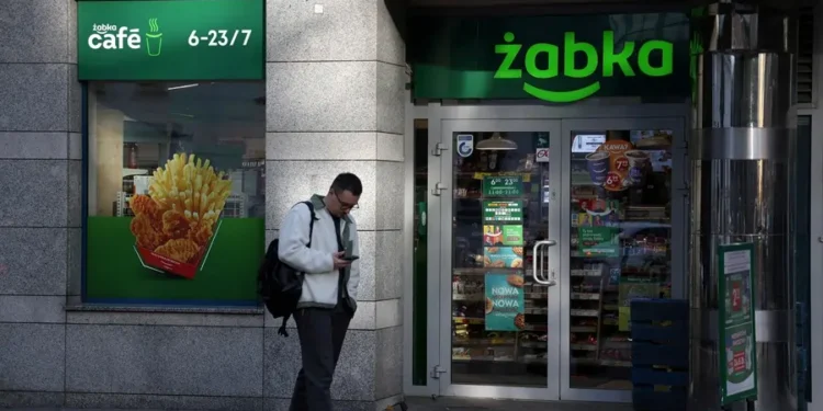 Man outside Żabka convenience store, Poland.