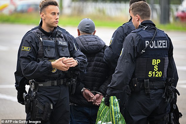 German police officers detain a man on the German/French border in Kehl, western Germany