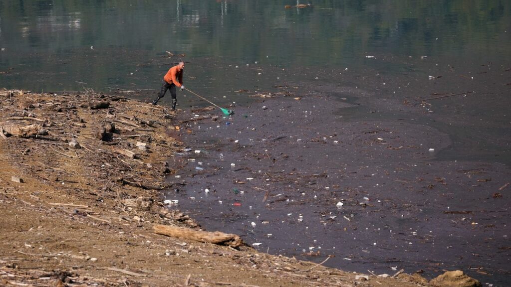 Residents and activists in central Bosnia clean up a lake after massive floods