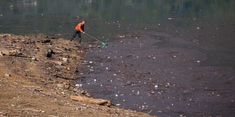 Residents and activists in central Bosnia clean up a lake after massive floods