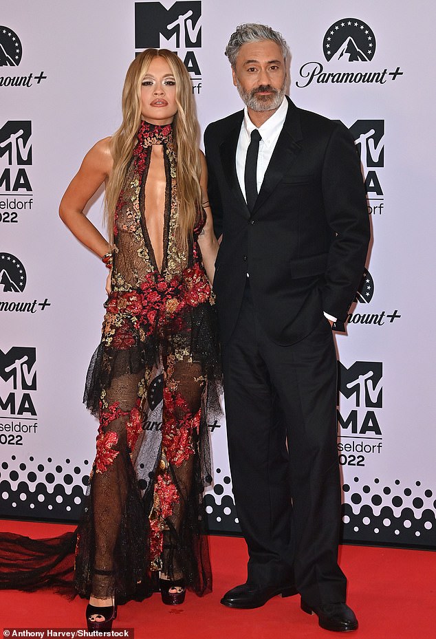 A source revealed: 'Talks between MTV and Rita's new management are ongoing and they're just ironing out the finer details' (pictured with her husband Taika Waititi at the MTV EMAs in 2022 in Germany)