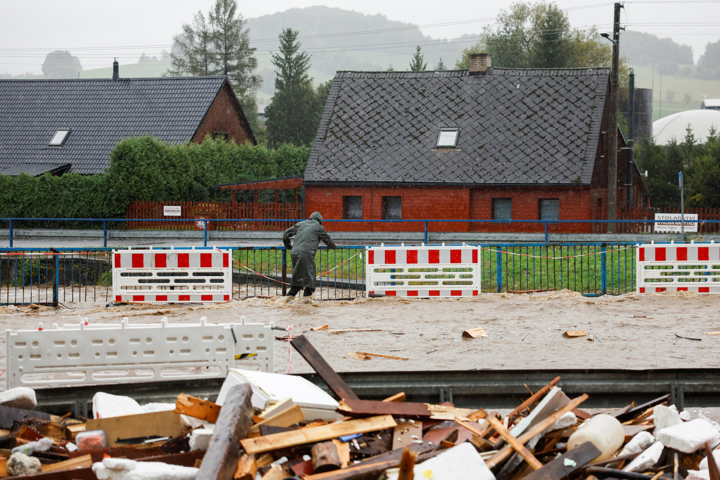 A person wades through a flood-affected road, following heavy rainfall in Jesenik, Czech Republic, on September 15, 2024. 