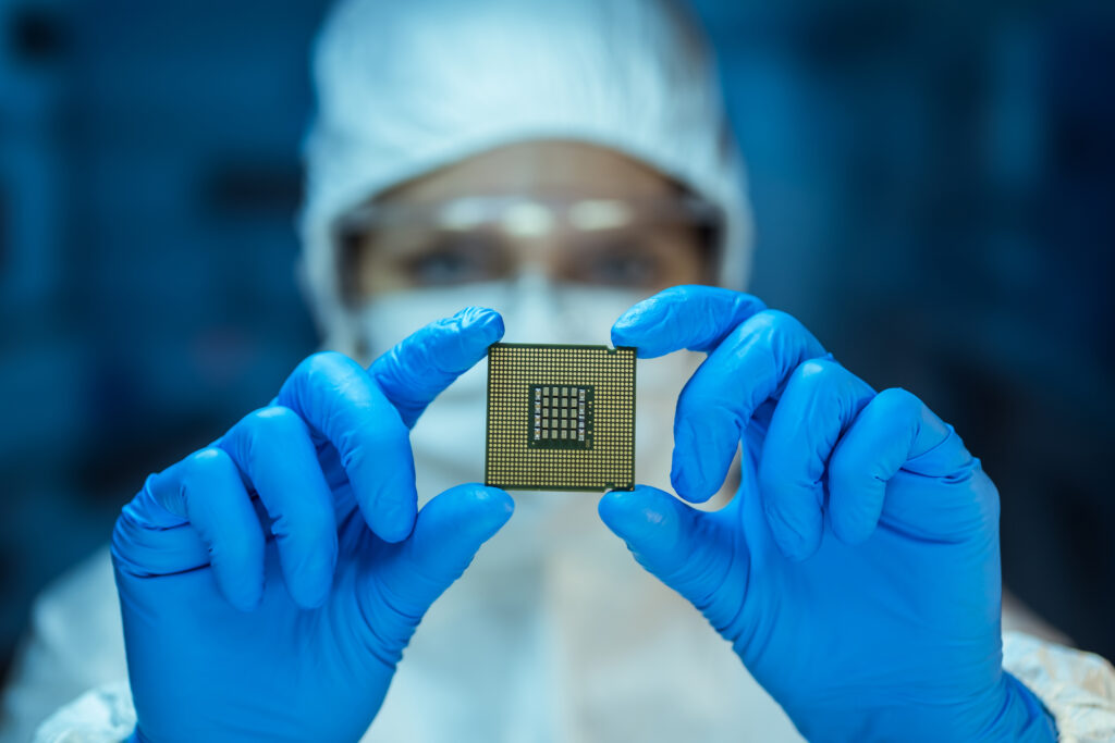 Engineer analyzing computer chip in laboratory