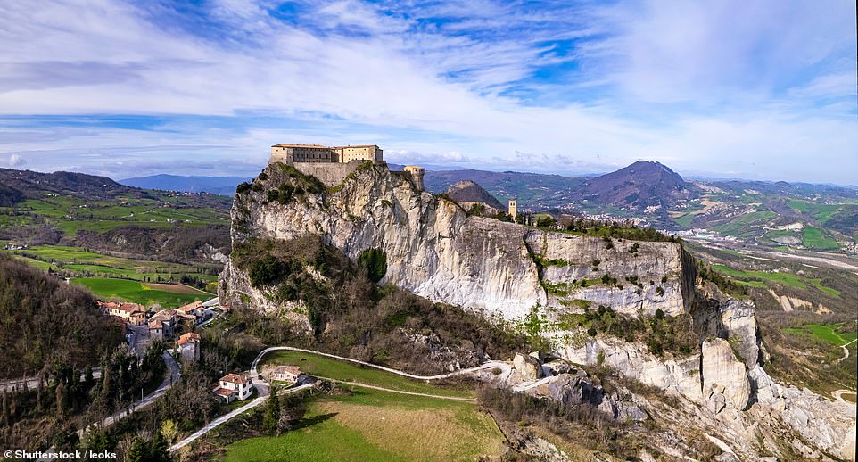 10. EMILIA-ROMAGNA, ITALY: 'The region of Emilia-Romagna has all of Italy’s best bits rolled into one,' says Time Out, noting that its ancient city of Ravenna has eight Unesco World Heritage Sites and culinary hotspots that include Modena, Parma and Bologna. Above is the region's San Leo medieval castle