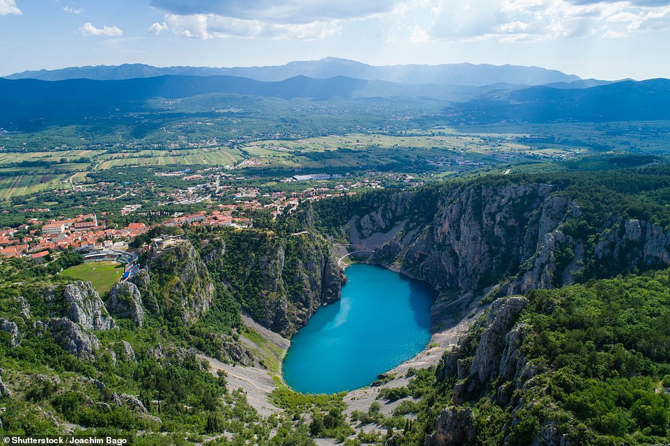 16. IMOTSKI LAKES, CROATIA: 'Across most of the Dalmatian hinterland that separates Croatia from Bosnia and Herzegovina,' says Time Out, 'you’ll only find goats and old locals wandering the barren terrain. Interrupting this moon-like landscape are two bright lakes, each named after their water colour, fringing the solitary yet thriving town of Imotski.' They are the swimmable Blue Lake (above) and the iron-oxide saturated Red Lake ('admired from above')