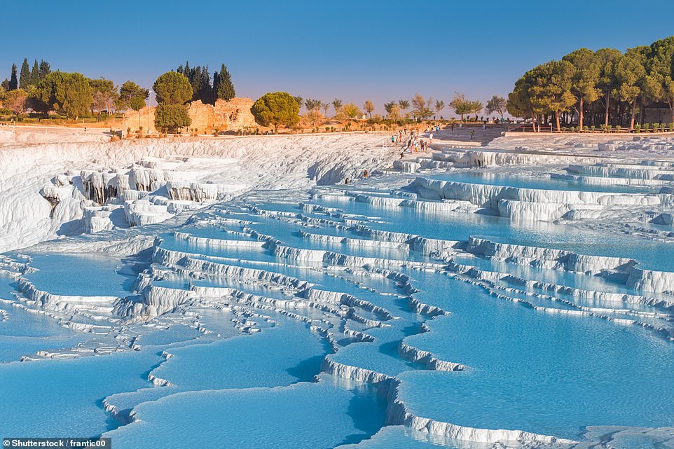 20. PAMUKKALE, TURKEY: Here, visitors can immerse themselves in 'mineral-rich thermal waters flowing down white travertine terraces' (above) and explore Roman ruins