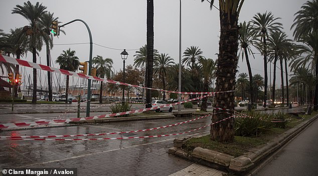 Areas on the main promenade of Palma are cordoned off to avoid dangers from rain or wind