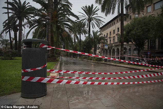 Areas on the main promenade of Palma are cordoned off to avoid dangers from rain or wind