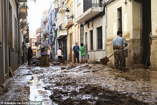 Residents begin the laborious process of cleaning their homes after the brutal flooding