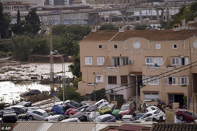 Vehicles are seen piled up after being swept away by floods in Valencia, Spain, Thursday, Oct. 31, 2024