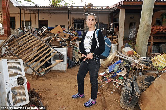 Rosalia Martinez Santos, 50, beside her summer house in the area of Cheste after suffering from flood damage