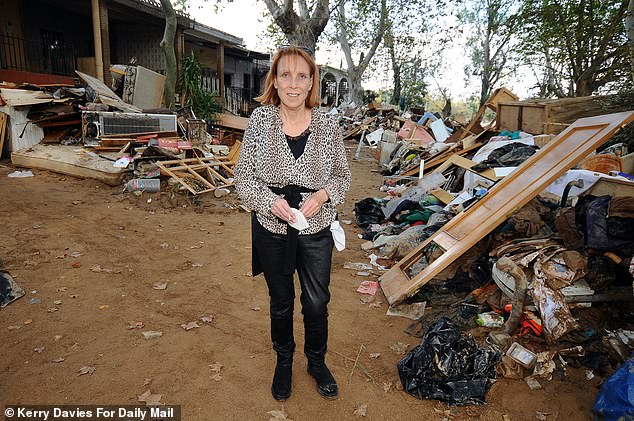 Daily Mail writer Sue Reid pictured at a row of heavily damaged houses in the flood hit Spanish town of Cheste