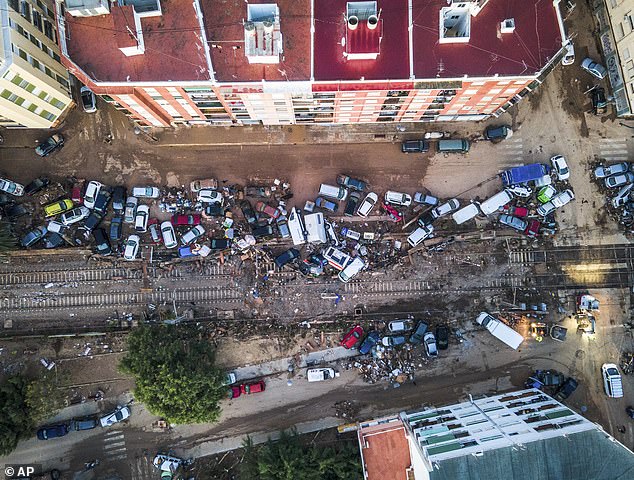 Vehicles pile up in the streets caused by a storm that left hundreds dead or missing in Alfafar, Valencia