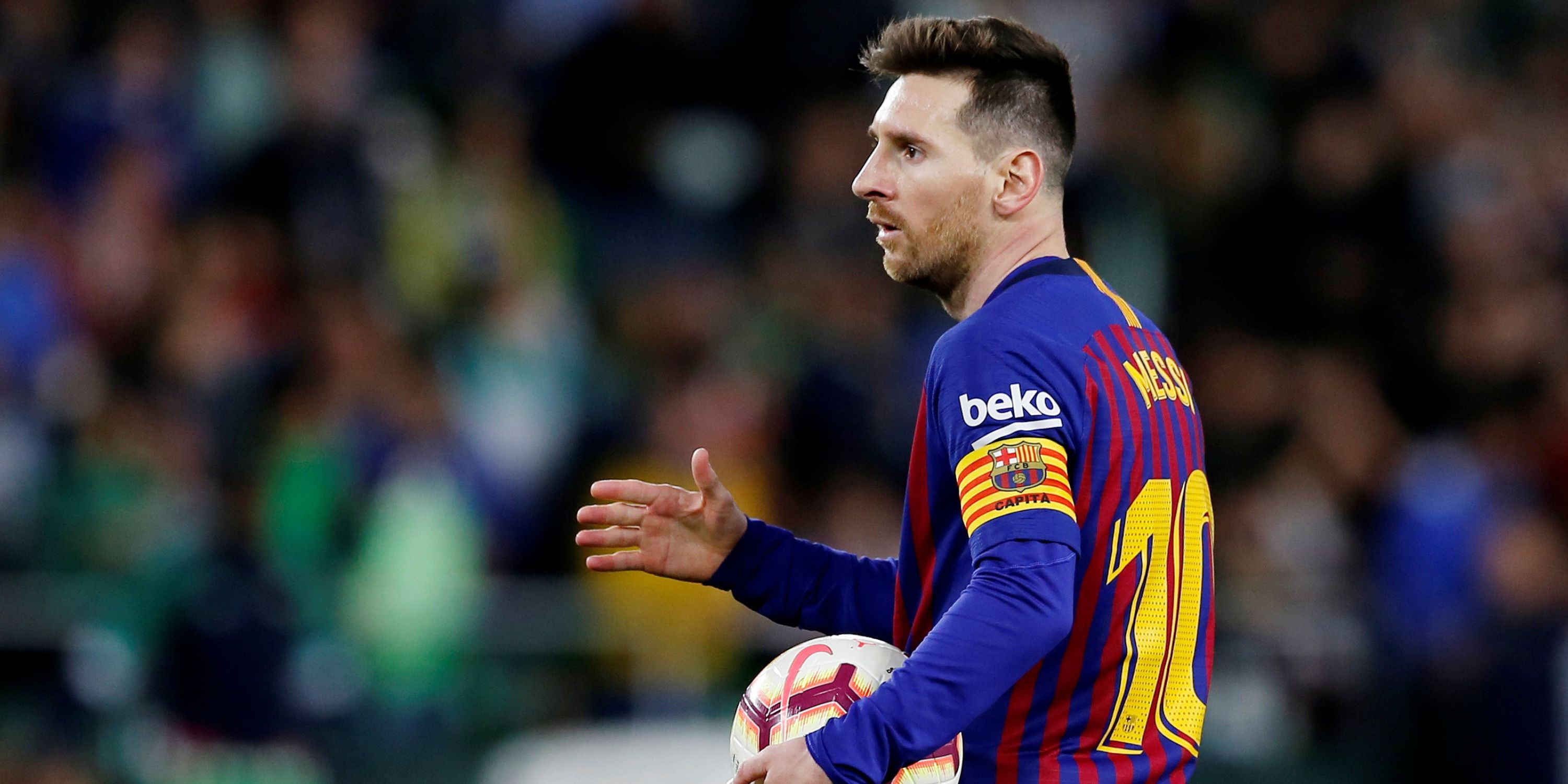 Lionel Messi holds the match ball after a hat-trick