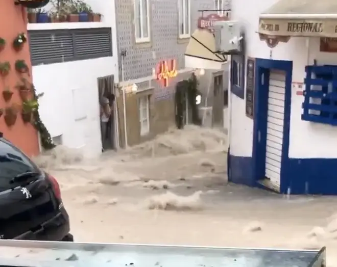 Videos have been shared on social media showing water gushing through downtown Albufeira
