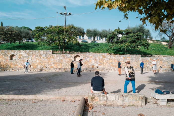 Residents of Fayence play pétanque next to the village’s main car park